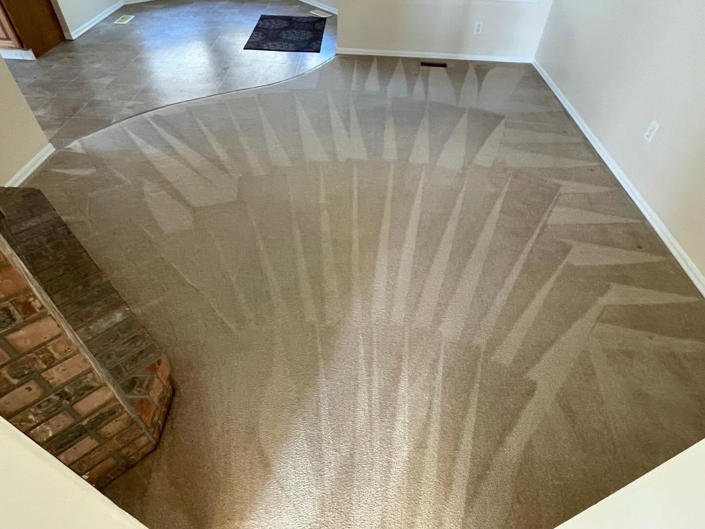 After — Before and after carpet stain removal in an Okanagan living room — blotchy soiling lifted to a clean, groomed pile