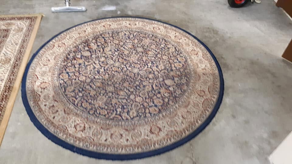 Round blue and cream oriental area rug cleaned by Pro-Steam Plus in Kelowna