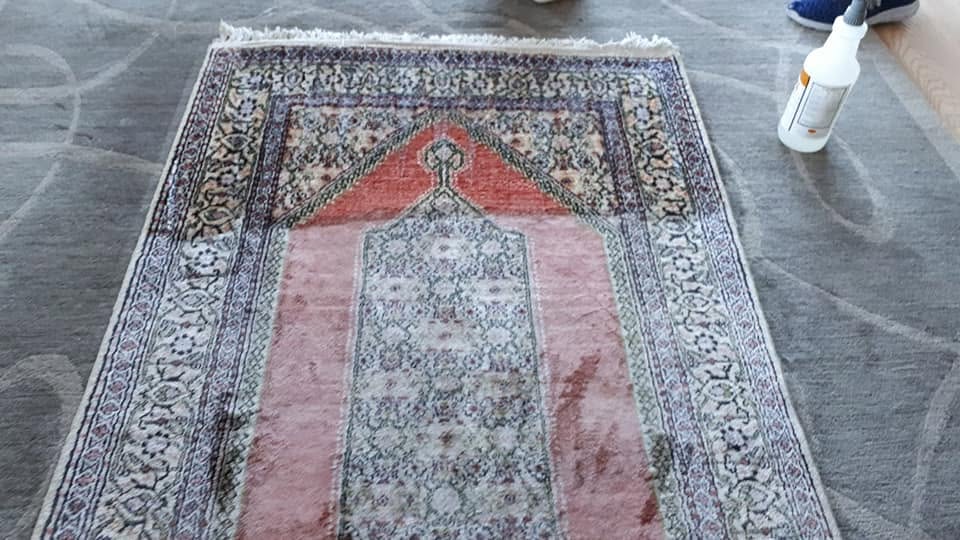 Silk-blend prayer rug being cleaned with a dye-safe solution