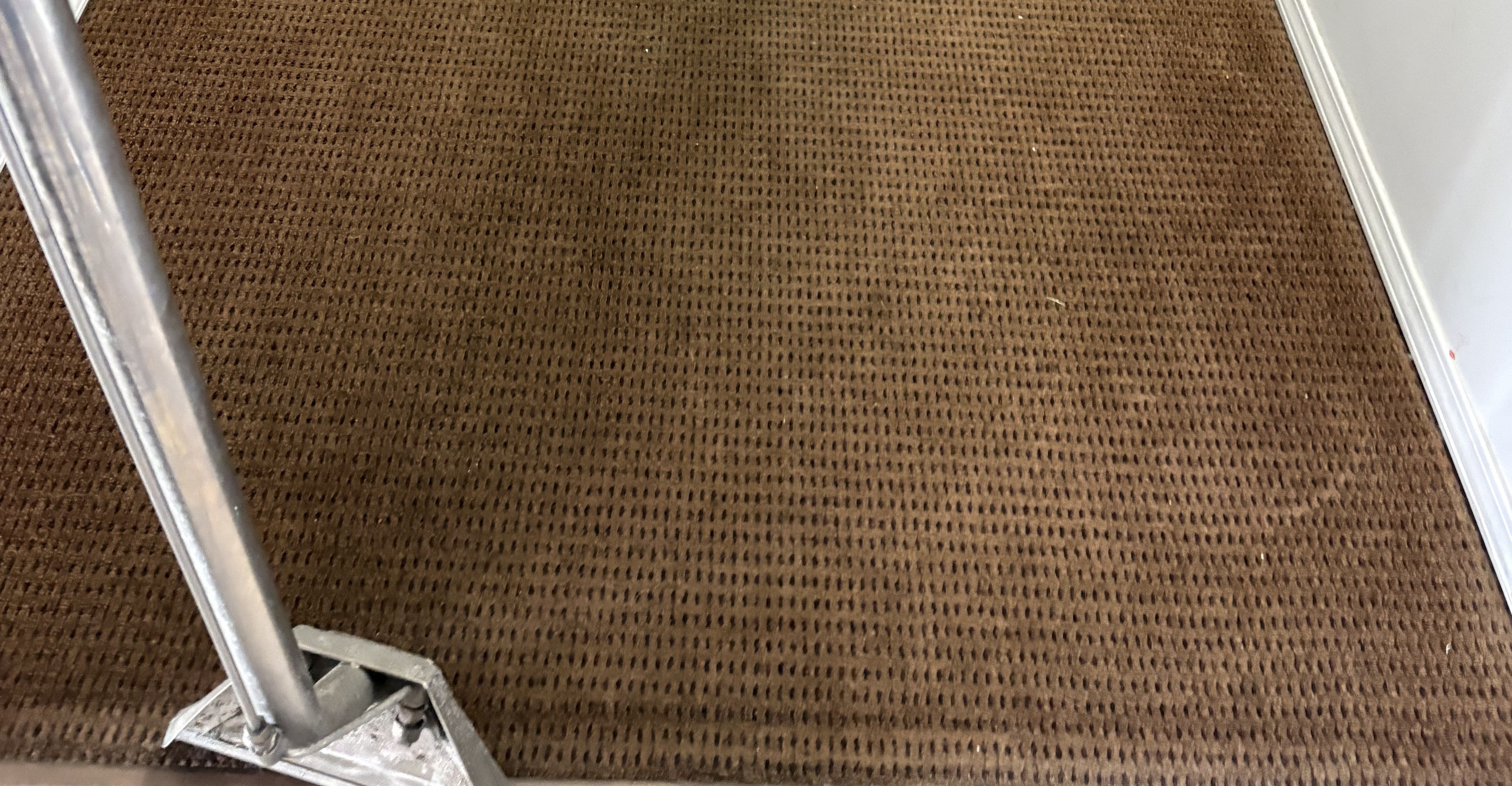 Before — Before and after commercial carpet cleaning on an office hallway floor — the far end came up freshly groomed in a single pass